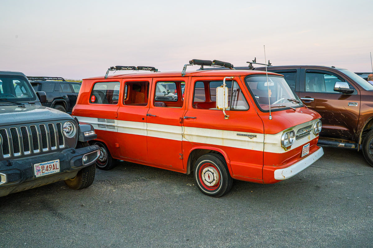 An orange-and-cream van brings a generous measure of character to the end of a beach day.