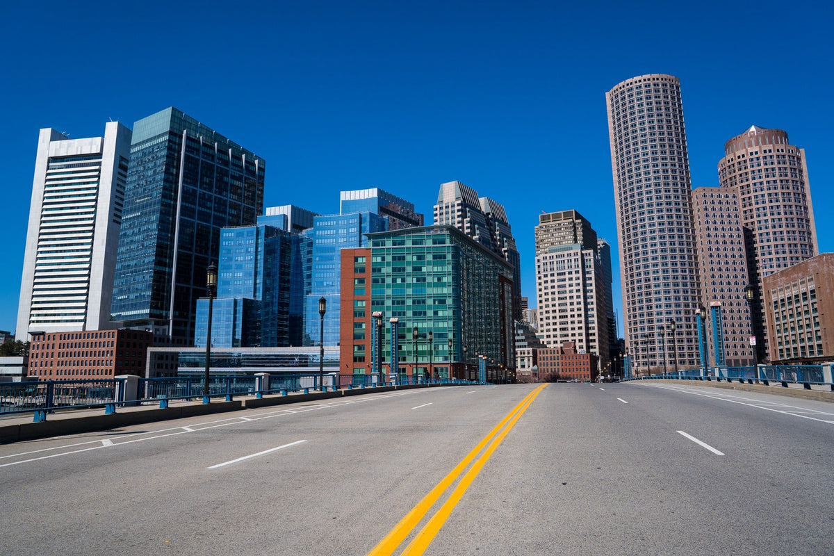 An empty bridge leads toward Boston's downtown skyline.