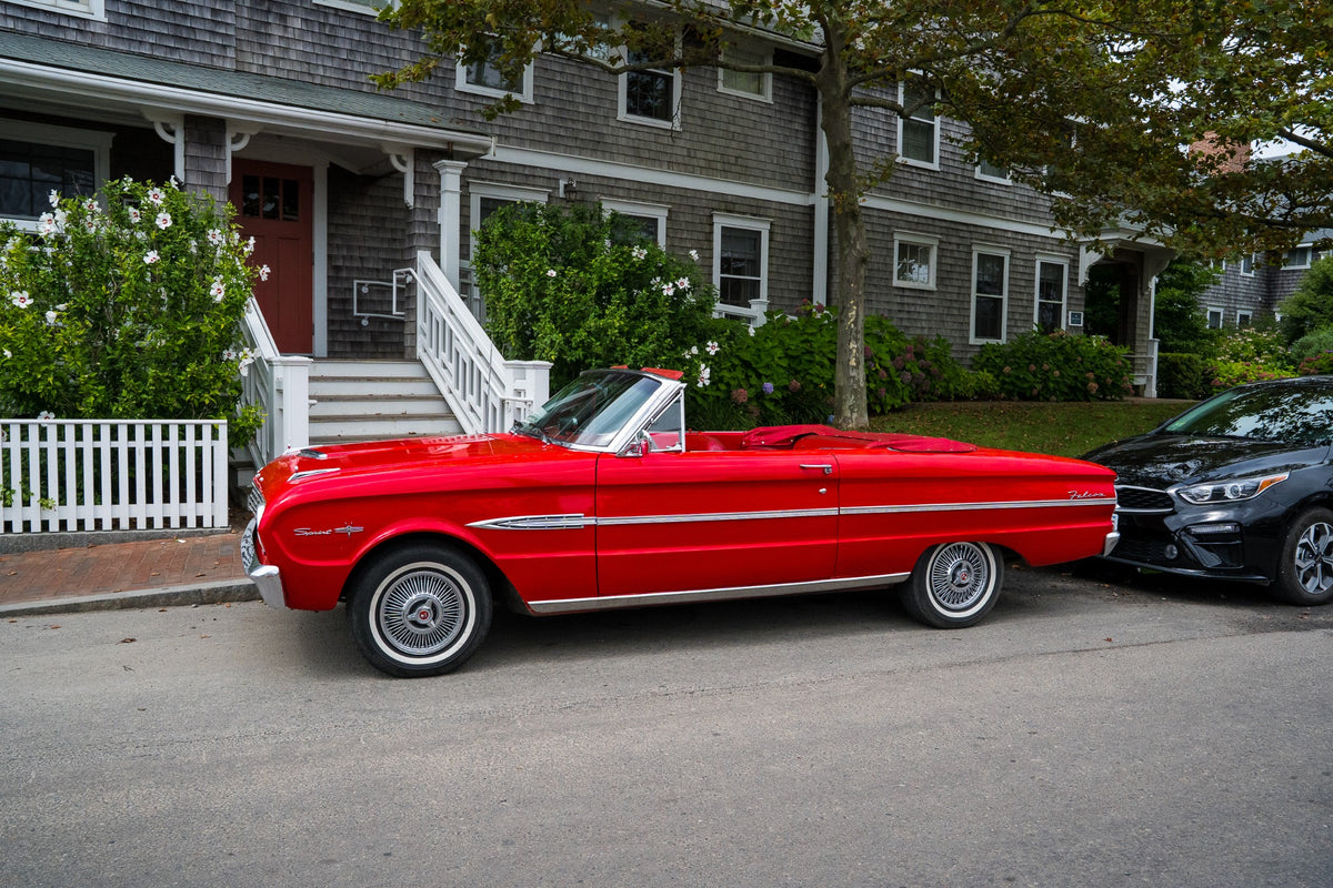 A scarlet convertible brings a flash of old-fashioned glamour to Nantucket’s weathered shingles.